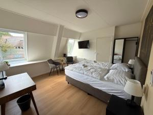 Ένα ή περισσότερα κρεβάτια σε δωμάτιο στο Herberg van Loon