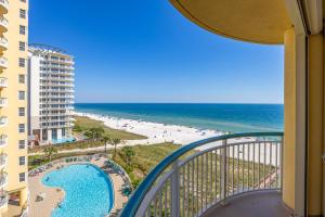 a view of the beach from the balcony of a resort at Beach Colony Tower 7A By Pkrm in Pensacola