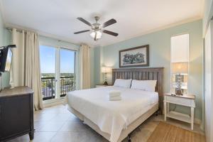 a bedroom with a bed and a large window at Beach Colony Tower 7A By Pkrm in Pensacola +32 photos
