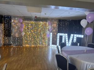 a room with a dance floor with purple balloons at Deincourt Hotel in Newark upon Trent