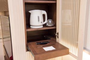 a coffeemaker sitting on a shelf in a kitchen at remm Roppongi in Tokyo