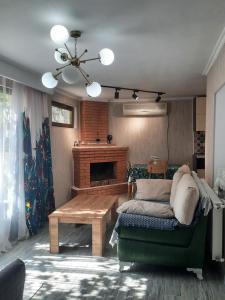 a living room with a couch and a fireplace at Maganiskhedi in Mtskheta
