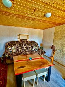 a bedroom with a bed and a wooden ceiling at The Secret Garden House in Ijevan