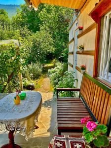 a patio with a table and a bench and a window at The Secret Garden House in Ijevan