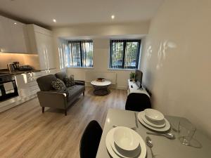 una sala de estar con un sofá y una mesa con platos encima. en Cozy Studio in Solihull with Parking - NEC or Airport, en Solihull