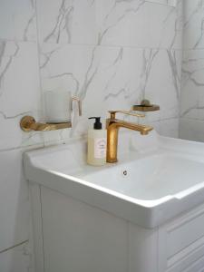 a bathroom sink with a bottle of soap on it at 부산 광안리 B&B stay in Busan +17 photos