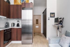 a kitchen with a stainless steel refrigerator in a room at Private Studio Apt with Best Location in Helsinki +17 photos