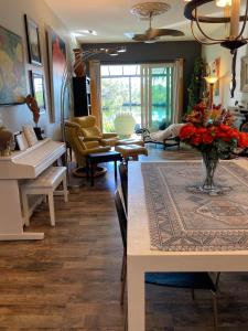 ein Wohnzimmer mit einem Klavier und einer Vase aus Blumen in der Unterkunft The Beach House Zen Place Luxury Amazing Views in Naples