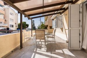 a patio with a table and chairs on a balcony at Levante - 2-BR Apt & Terrace in Larnaca in Larnaka