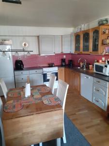 a kitchen with a wooden table with chairs and a table and a table andheastern at Paradis in Norway in Nord-Lenangen