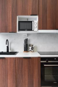 a kitchen with a microwave and a stove at Private Studio Apt with Best Location in Helsinki