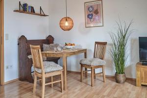 a dining room with a table and two chairs at Refugium - Möhneseeblick in Möhnesee