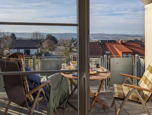 a table and chairs on a balcony with a view at Refugium - Möhneseeblick in Möhnesee
