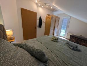 a bedroom with a bed with two shoes on it at Refugium - Möhneseeblick in Möhnesee