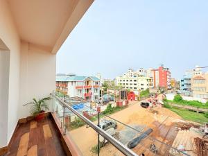 a balcony with a view of a city at Rooftop Sea View Marine Drive Road Duren- Beach-Resort # Jagannath Temple #Fully Air Condition with All Premium Rooms With Attached #Balcony Free Wifi & Lift Facilities- Top Rated Hotel in Puri