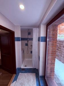 a bathroom with a shower with a shower curtain at Apartmán v Dráze in Zásada