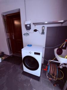a washing machine in a bathroom with a sink at Apartmán v Dráze in Zásada +3 photos