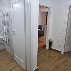 a room with a white door and a hallway at FourSeasons Residence in Braşov