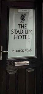 a sign on the door of a hotel at The Stadium Hotel Anfield in Liverpool