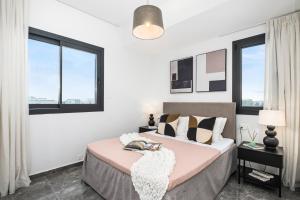 リマソールにあるNoir Luxury Residences by Nomadsのベッドが2つと窓が2つある寝室