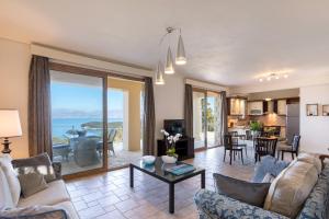 a living room with a view of the ocean at Three Stones Villas by Rodostamo Collection in Kassiopi