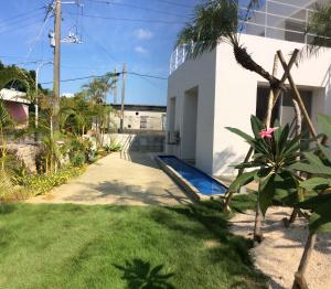 a backyard of a house with a swimming pool at Seaside House Nirai in Miyako-jima
