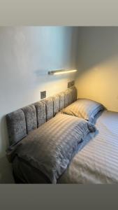 a bed in a bedroom with a headboard at The Stadium Hotel Anfield in Liverpool +3 photos