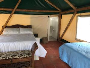 Postel nebo postele na pokoji v ubytování Glamping El Establo