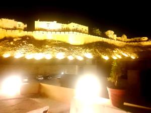 a view of a city at night with lights at Hostel sakura Jaisalmer in Jaisalmer