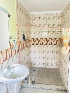 a bathroom with a toilet and a sink at Spacious Farm House Natadola in Sigatoka