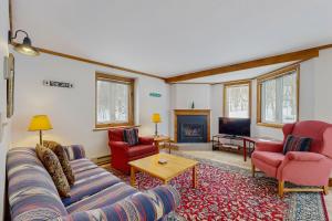 a living room with a couch and two chairs and a tv at Slopeside 4001 in Jay