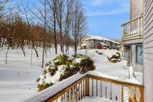 a porch covered in snow next to a house at Slopeside 4001 in Jay