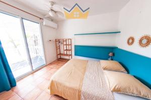 a bedroom with a bed and a large window at La Villa du soleil in Les Trois-Îlets +15 photos