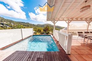 a swimming pool on the deck of a house at La Villa du soleil in Les Trois-Îlets
