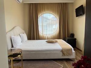 a bedroom with a large bed and a window at Hotel Silver in Sozopol +48 photos