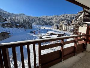 a view from a balcony of a snow covered ski slope at Résidence Christiana 406 Clés Blanches Courchevel in La Tania
