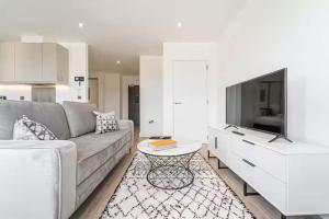 a living room with a couch and a tv at Contemporary Studio near NEC & Airport Free Parking in Olton