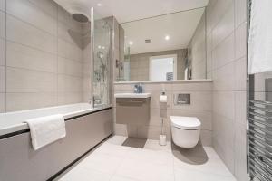 a bathroom with a toilet and a sink at Contemporary Studio near NEC & Airport Free Parking in Olton +11 photos