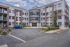 a parking lot in front of a large building at Contemporary Studio near NEC & Airport Free Parking in Olton