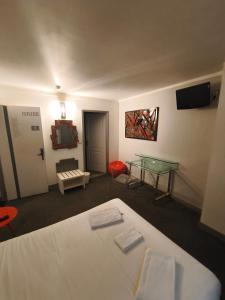 卡奥尔Le coin des Halles的配有床和玻璃桌的房间