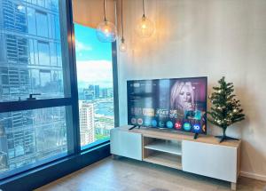 a living room with a television and a christmas tree at 3415 - 2BR Luxury Suite #Free Car Parking# Retreat Near Crown in Melbourne