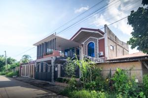 a house on the side of a street at RedDoorz at R2K Pension House in Puerto Princesa City