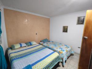 a bedroom with two beds in a room at Kumho in Medellín