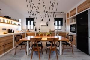 a kitchen with a wooden table and chairs at Villa Anamnesia, Stelida Naxos in Stelida