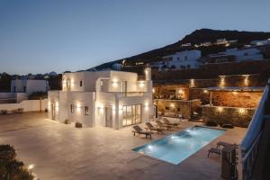 a villa with a swimming pool at night at Villa Anamnesia, Stelida Naxos in Stelida