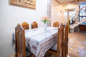 a table and chairs with a vase of flowers on it at RedDoorz at R2K Pension House in Puerto Princesa City
