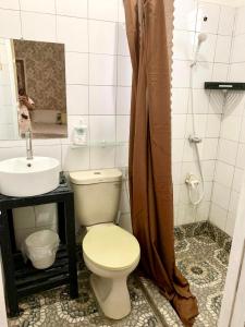 a bathroom with a toilet and a sink at Anton and Isabel Bangued- 2BR for 5 in Bangued +19 photos