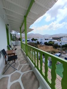 a balcony of a house with a green railing at Aegaia Residencies in Katapola