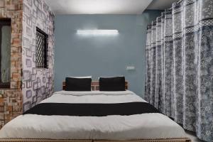 Ένα ή περισσότερα κρεβάτια σε δωμάτιο στο Hotel O Peaceful Paradise