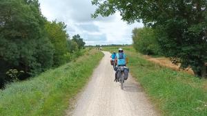 奥尔良La Parenthèse - studio calme proche cathédrale的两个人骑着自行车沿着土路走